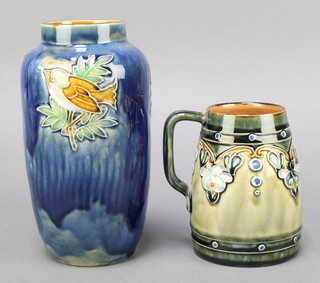 An Art Nouveau Royal Doulton green salt glazed tankard, impressed  Royal Doulton 7358 5" and a cylindrical blue glazed Doulton vase decorated birds impressed Royal Doulton X8912A 9462 Made in England 8"  