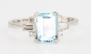An 18ct white gold aquamarine and diamond ring, the centre stone approx. 1.3ct, each shoulder with 2 brilliants and 1 baguette cut diamond, size N 1/2