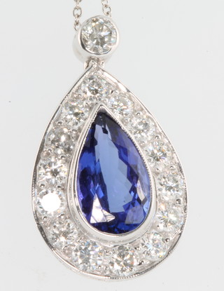 A white gold pear shaped tanzanite and diamond pendant, the centre stone approx. 4.25ct surrounded by brilliant cut diamonds 1.80ct, on an 18ct white gold chain 