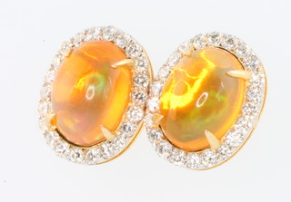 A pair of 18ct yellow gold oval fire opal and diamond cluster ear studs, the opals approx. 2.8ct the diamonds approx. 0.65ct 