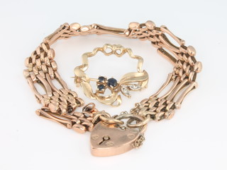 An Edwardian 9ct yellow gold gate bracelet 12.9 grams and a 9ct yellow gold gem set ribbon brooch 3.4 grams