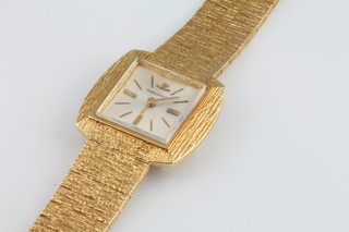 A lady's 18ct yellow gold bark finished Jaeger Le Coultre watch on a ditto bracelet, gross weight 45.71 grams 