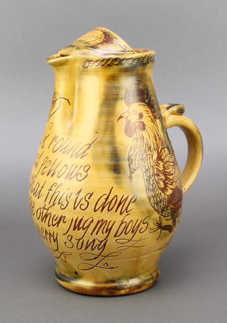 A 17th/18th Century style spouted pottery jug with motto - Drink round my jovial fellows and when that is us done we'll have the other jug my boys and sing and merry song, spout dated 1977 9 1/2" 