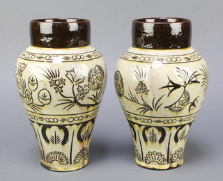 C H Brannam, a pair of brown slip glazed pottery vases with floral decoration, 1 marked C H Brannam North Devon 9" 
