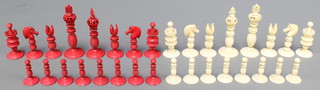 A 19th Century carved and stained ivory chess set with baluster turned stems, the King 4" 