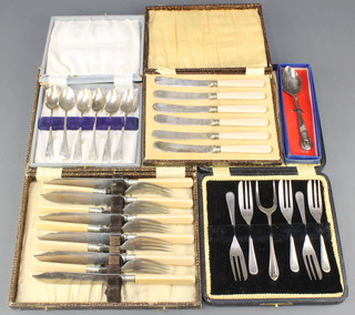 A cased set of silver plated forks, 4 other cased sets