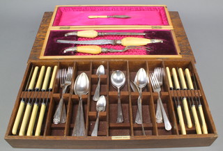 A Victorian cased silver mounted carving set with ivory handles and a Georgian silver butter knife together with a quantity of Art Deco cutlery contained in a wooden cutlery box 