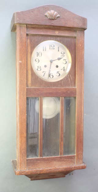 A 1930's striking wall clock with 7 1/2" silvered dial and Arabic numerals contained in an oak case 