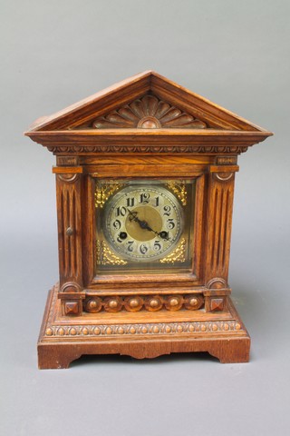 A Victorian striking bracket clock with square gilt dial and silvered chapter ring contained in a carved oak case 