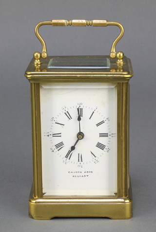 A carriage clock with enamelled dial and Roman numerals contained in a gilt metal case marked Cahoon Bros. Belfast 
