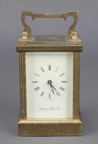 A mantel clock with enamelled dial and Roman numerals, contained in a gilt metal case by the London Clock Co. 