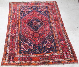 A red and blue Afghan style rug with diamond medallion to the centre 117" x 84 1/2" 