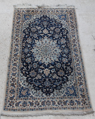 A Persian blue and white ground Nain rug with central medallion 75" x 45" 