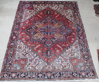 A Persian red, blue and white ground Heriz carpet with stylised diamond to the centre 142" x 109" 