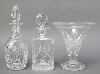 A cut glass vase of trumpet form 8 1/2", a Royal Doulton cut glass club sahped decanter and stopper 12", a Royal Doulton cut glass spirit decanter and stopper 9" 
