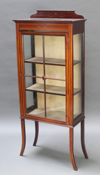 An Edwardian inlaid mahogany display cabinet with raised back, fitted shelves enclosed by astragal glazed panelled doors, raised on splayed supports 57"h x 24"w x 11 1/2"d 