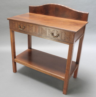 A Chippendale style mahogany side table with raised arched back, the base fitted 2 drawers with blind fret work decoration and brass swan neck drop handles with raised undertier, raised on square tapering supports 39 1/2"h x 36"w x 19"d 