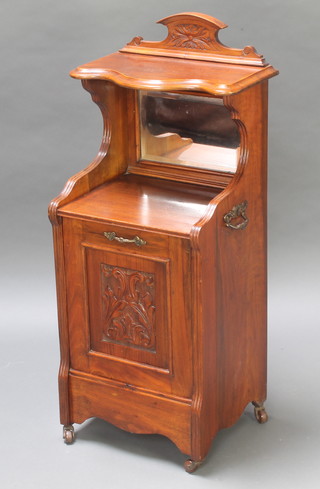 A Victorian carved walnut coal purdonium with raised back, fitted a recess with bevelled plate mirror, the base fitted a fall front with brass handles to the sides 29"h x 15"w x 13"d 