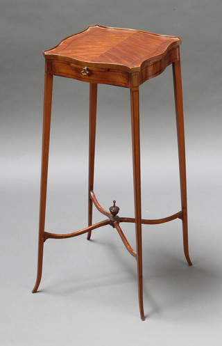 An Edwardian Georgian style mahogany urn table of serpentine outline, fitted a slide and raised on square tapering supports with X framed stretcher 26" x 10 1/2" square