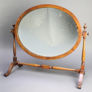 A 19th Century oval bevelled plate dressing table mirror contained in a mahogany swing frame 18"h x 21"w 