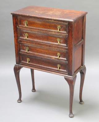 A 17th Century style oak chest of 4 long drawers with brass drop handles, raised on cabriole supports 36"h x 24"w x 12"d 