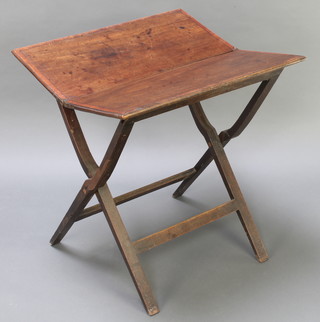 A 19th Century rectangular folding coaching table with crossbanding to the top, raised on X framed folding supports 28"h x 26"w x 12" when closed x 24" when open 