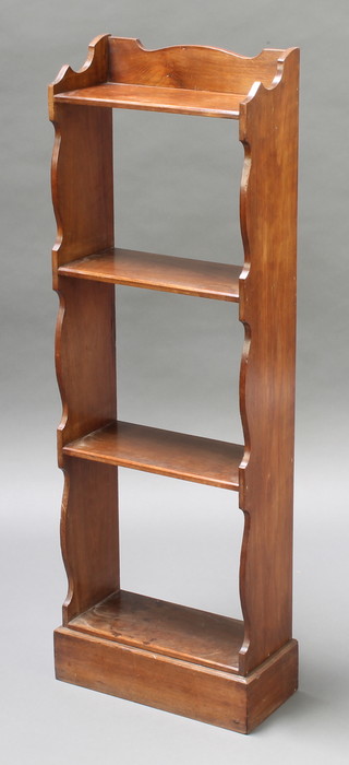 An Edwardian 4 tier narrow bookcase with raised shaped back on a platform base 38 1/2"h x 13"w x 6"d 