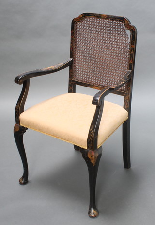 A 1930's black lacquered chinoiserie style open arm chair with woven cane back and upholstered seat, raised on cabriole supports 