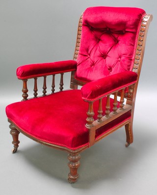 A Victorian carved oak show frame armchair with bobbin turned decoration on turned supports 