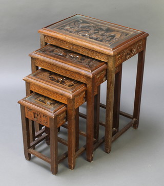 A nest of 4 Chinese carved hardwood interfitting coffee tables, the tops carved scenes of warriors 26"h x 20"w x 14"d, 22"h x 16 1/2"w x 12"d, 18 1/2"h x 13"w x 10 1/2"d, 15"h x 9 1/2"w x 8 1/2"d 