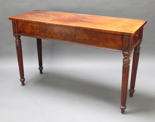 A 19th Century rectangular mahogany side/serving table raised on 4 turned and reeded supports 37"h x 60"w x 21 1/2"d 