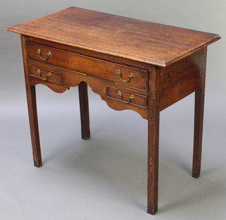 An 18th Century oak side table fitted 1 long and 2 short drawers, raised on square tapered supports 27 1/2"h x 33"w x 17"d 