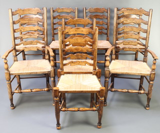 A set of 8 elm Lancashire ladder back dining chairs, 6 standard, 2 carvers, with woven rush seats, raised on turned supports