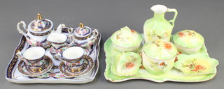 A modern miniature tea set comprising teapot, milk jug, sugar bowl, 2 tea cups, 2 saucers and a tray together with a porcelain dressing table set 
