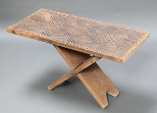 A rectangular Eastern carved hardwood stool raised on X framed supports 17" x 32 1/2" x 15"