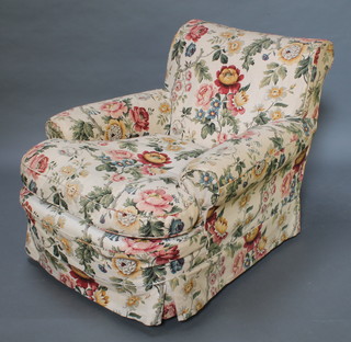A Howard style armchair upholstered in blue material with floral loose cover