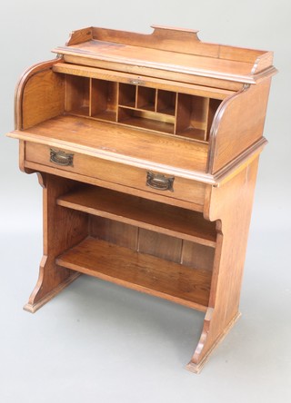 An Edwardian Art Nouveau oak roll top desk with three-quarter gallery and fitted interior above 1 long drawer with recess 41"h x 29 1/2"w x 18"d 