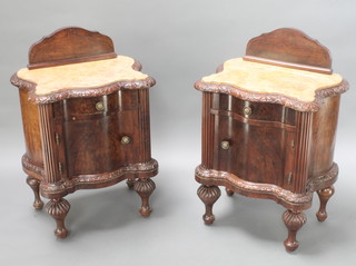 A pair of French Art Deco shaped mahogany bedside cabinets with raised backs and pink veined marble tops, fitted 1 long drawer above a double cupboard, on turned and fluted supports 35"h x 22"w x 16"d 