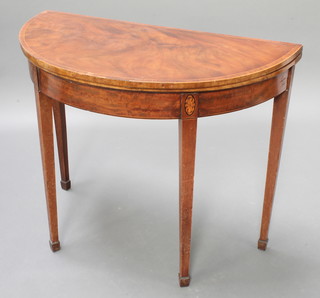 A 19th Century mahogany demi-lune card table with inlaid and crossbanded top, raised on 4 square tapering supports, spade feet 29 1/2" x 36"w x 17 1/2"d  