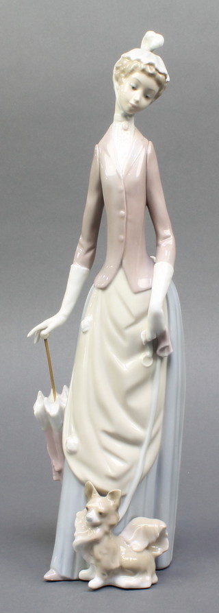 A Lladro figure of a lady with parasol and dog 14", boxed