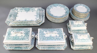 An Edwardian Alexandria pattern dinner service comprising 12 small plates, 6 medium plates, 11 dinner plates, 2 small tureens, stands and covers with ladles, 2 large vegetable dishes and stands and 3 graduated meat plates 
