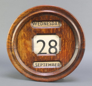 A perpetual calendar contained in a circular oak case 12" diam. 