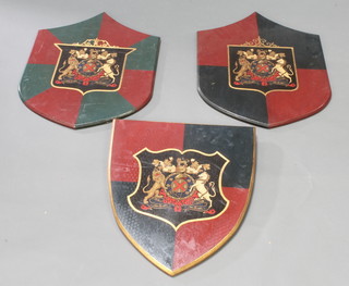 A pair of shaped painted wooden armorial shields 24" x 18" together with 1 other 20 1/2" x 18" 
