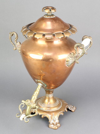 A 19th Century oval copper tea urn raised on panel supports 17" (1 handle missing)