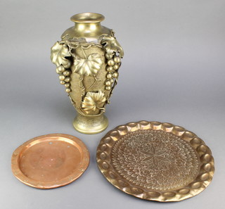 A gilt metal vase with vinous decoration 15" together with a circular Indian engraved tray 13" and a circular Art Nouveau copper tray 9" 