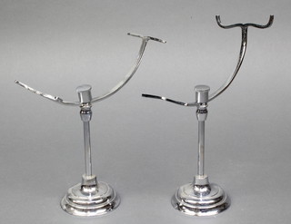 A pair of chromium plated milliners adjustable hat stands