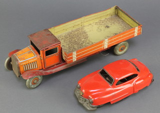 A tin plate clockwork model car 6 1/2" together with a tin plate model of a tipping lorry 12" 