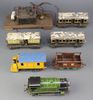 A Hornby clockwork tank engine converted to an electric three track together with 3 three track carriages, brake van and transformer 