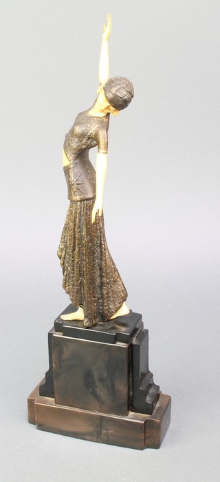 An Art Deco style figure of a standing lady raised on a marble effect base 15"