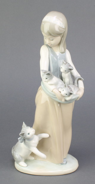 A Lladro figure of a girl holding kittens in her apron, with a cat at her feet M/270, 19", boxed